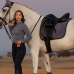 A rider standing by a horse