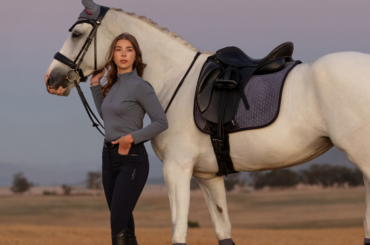 A rider standing by a horse