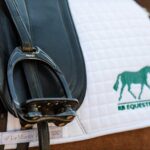 Flex-on stirrups on a saddle pad embroidered with the RB Equestrian logo