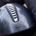 A rider carrying an Evoke riding helmet