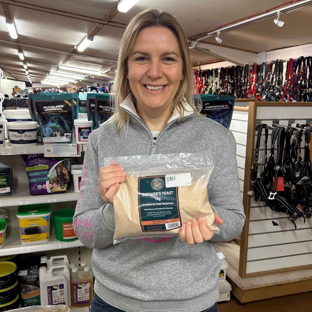 Kathryn Jaquet holding a pack of Equus Health Brewer’s Yeast
