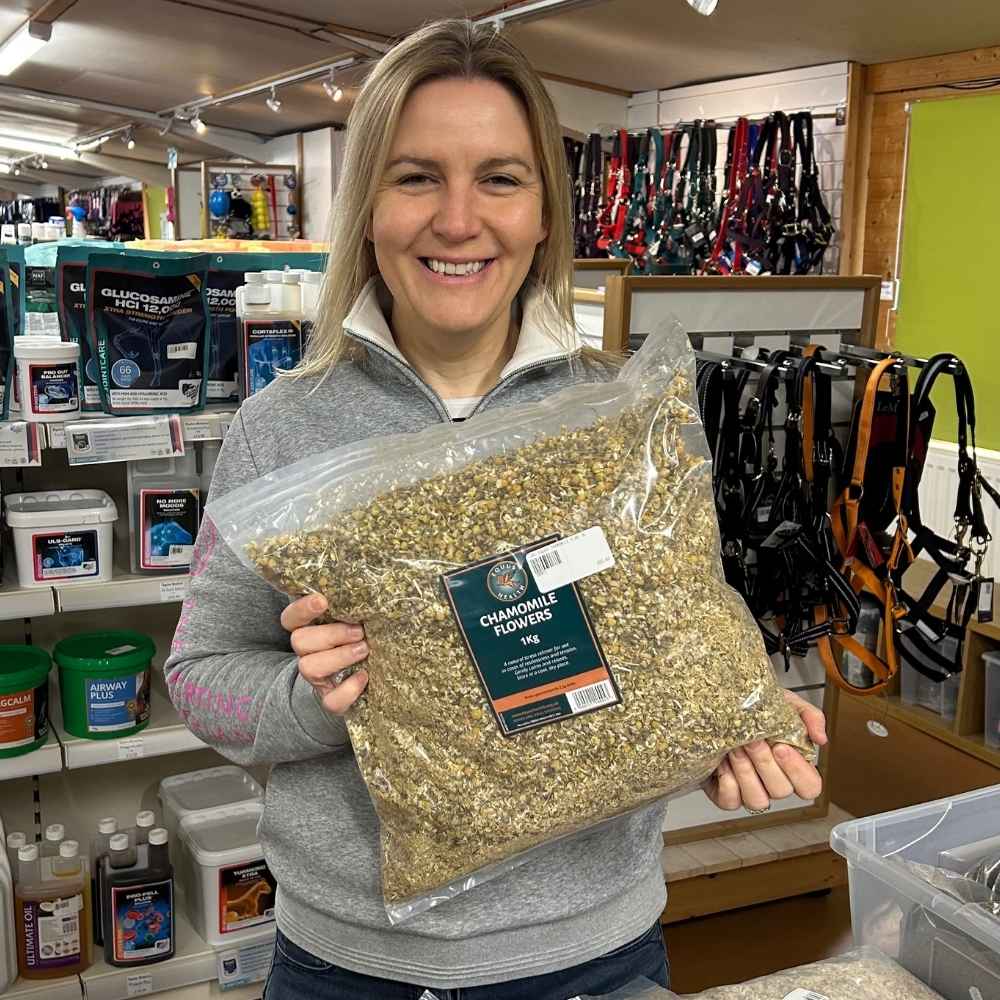 Kathryn Jaquet holding a pack of Equus Health Chamomile Flowers