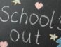 Schools out written over a blackboard